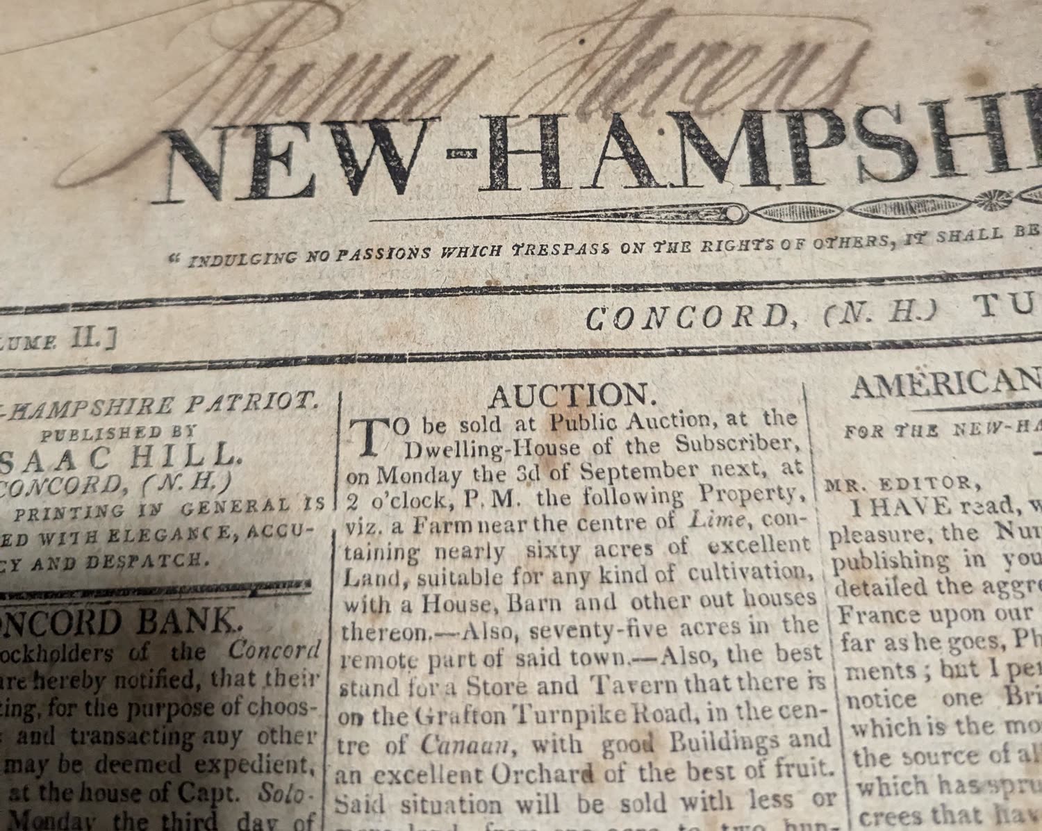 An original New Hampshire Patriot newspaper from Concord, its front page browned and signed in ink above the masthead